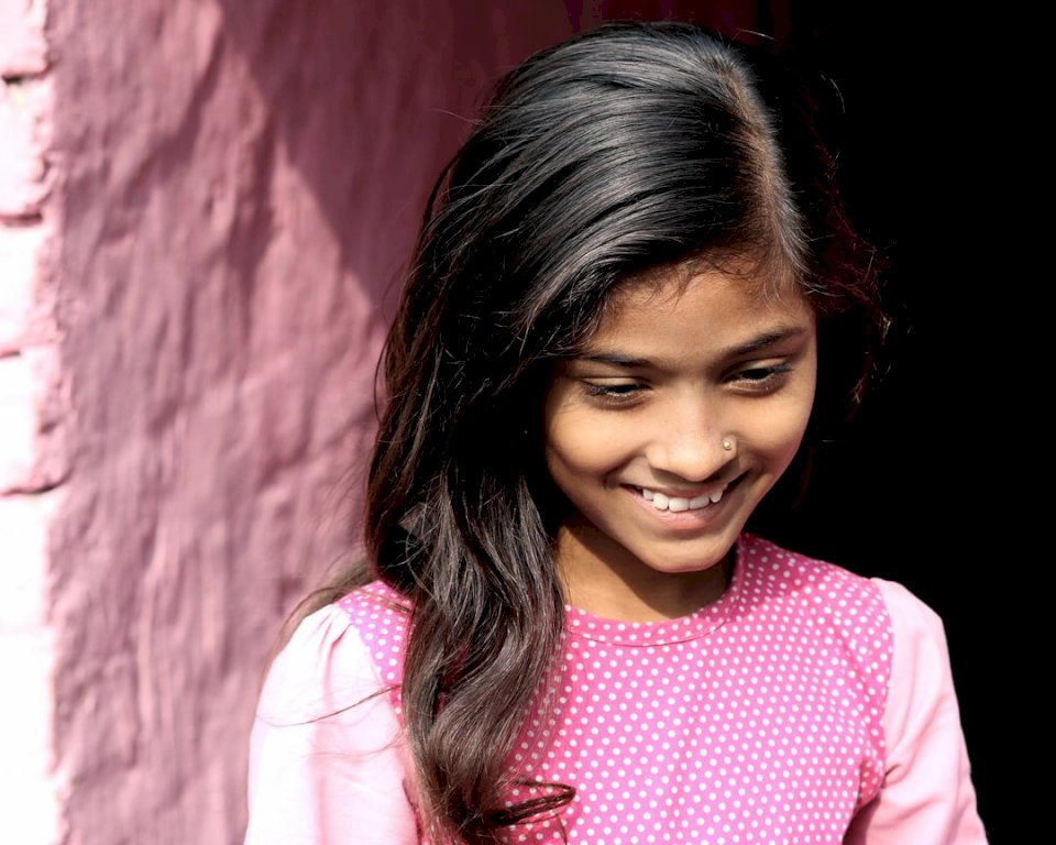 Uśmiechnięta dziewczyna w różowej koszuli puzzle online