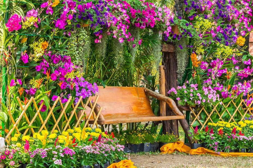 Obfitość kwiatów na domu z ławką do odpoczynku puzzle online