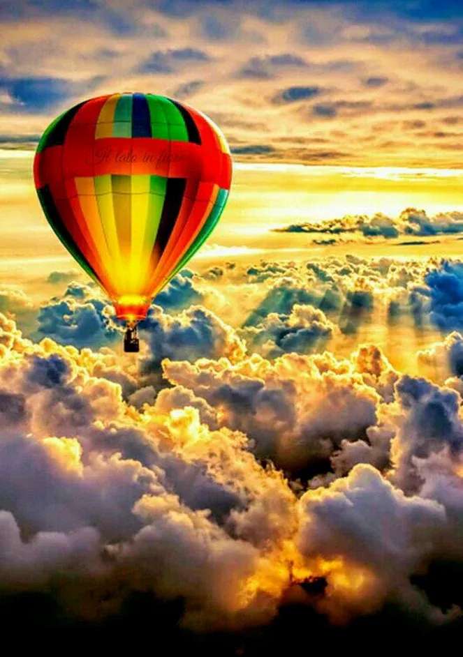 Kolorowy balon na ogrzane powietrze nad chmurami puzzle online