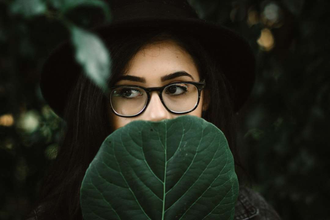 kobieta zakrywająca usta zielonym liściem puzzle online