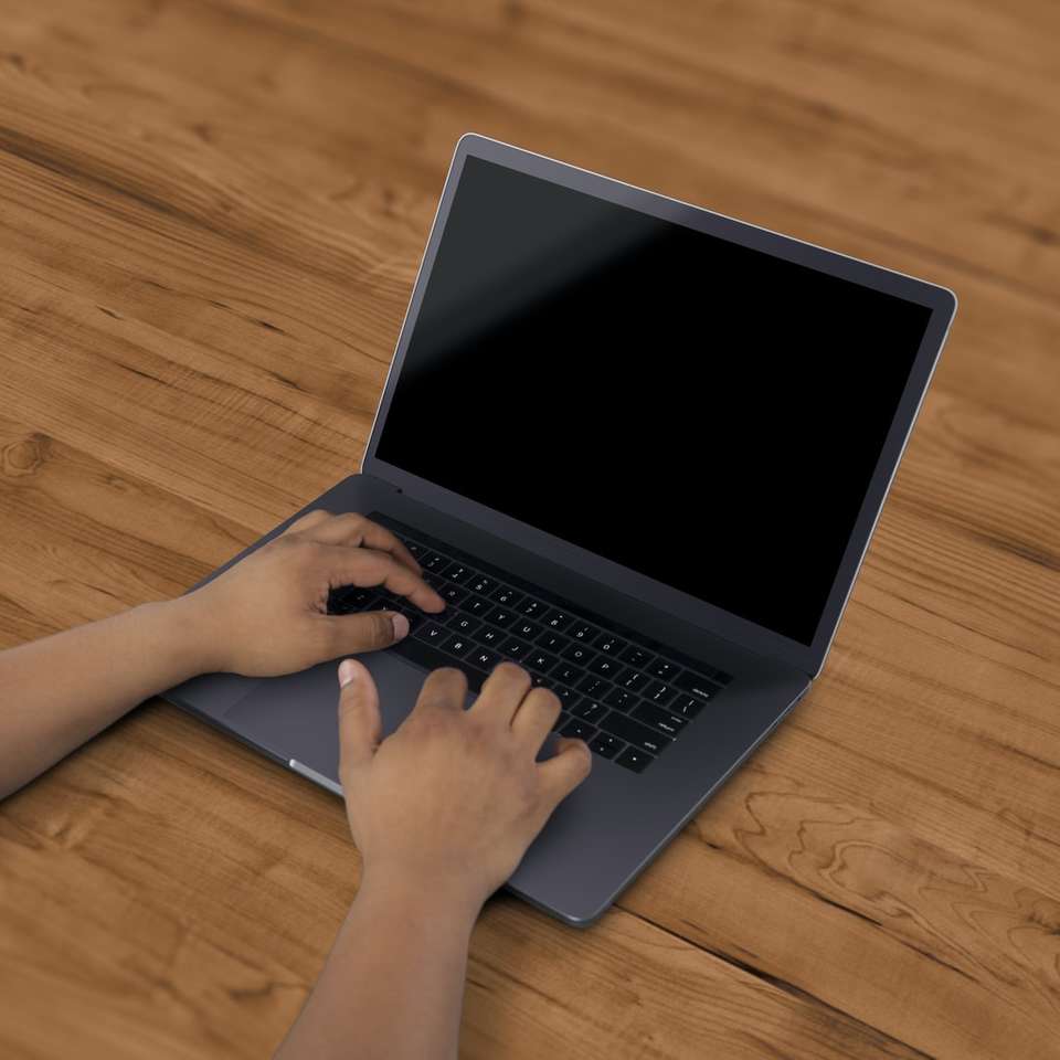 czarny laptop na brązowej powierzchni puzzle online