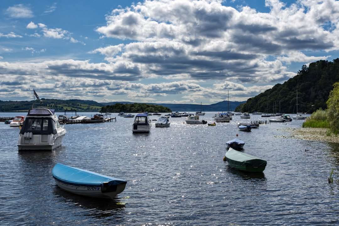 niebiesko-biała łódź na morzu pod białymi chmurami i błękitnym niebem puzzle online
