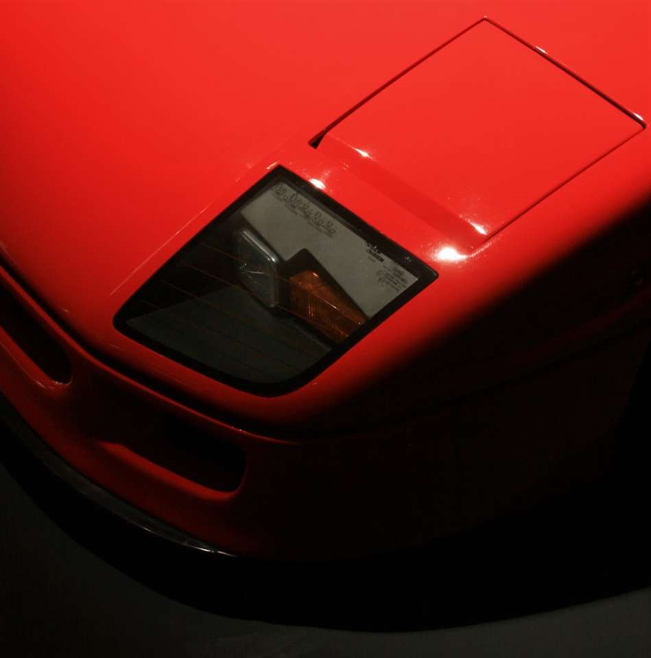 czerwony samochód ferrari w fotografii z bliska puzzle online