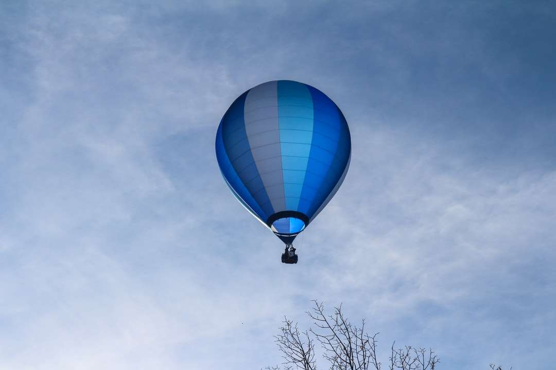 niebieski i biały balon na ogrzane powietrze pod błękitne niebo w ciągu dnia puzzle online