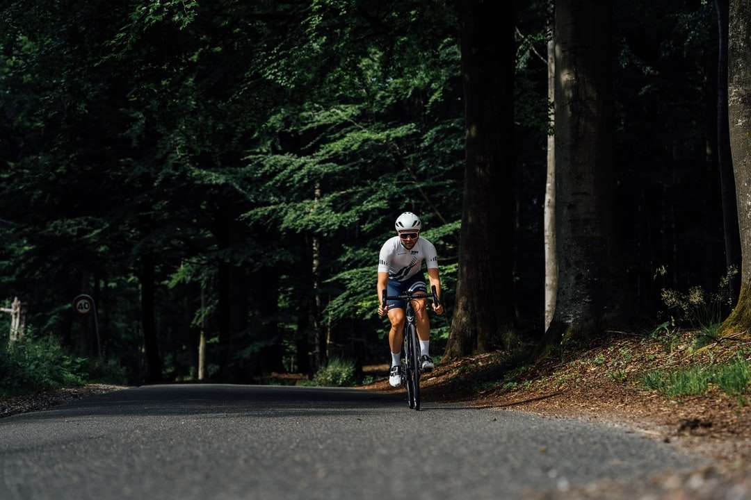 człowiek w białym kasku, jazda na rowerze na drodze w ciągu dnia puzzle online