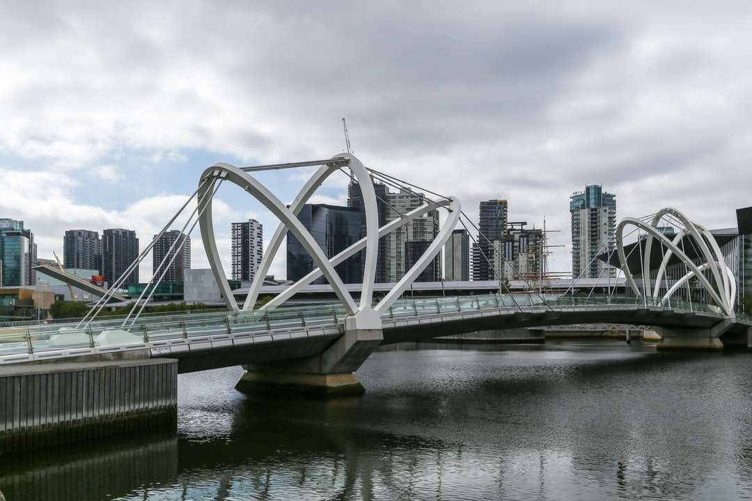 biały most nad rzeką pod zachmurzonym niebem w ciągu dnia puzzle online