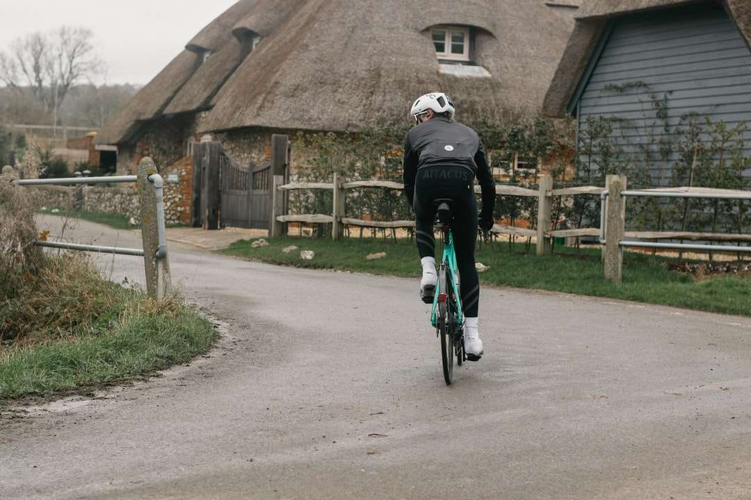 mężczyzna w czarnej kurtce, jazda na rowerze na szarej betonowej drodze puzzle online