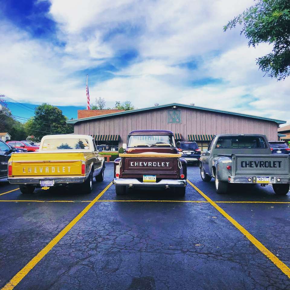 three assorted-color Chevrolet pickup trucks parking puzzle