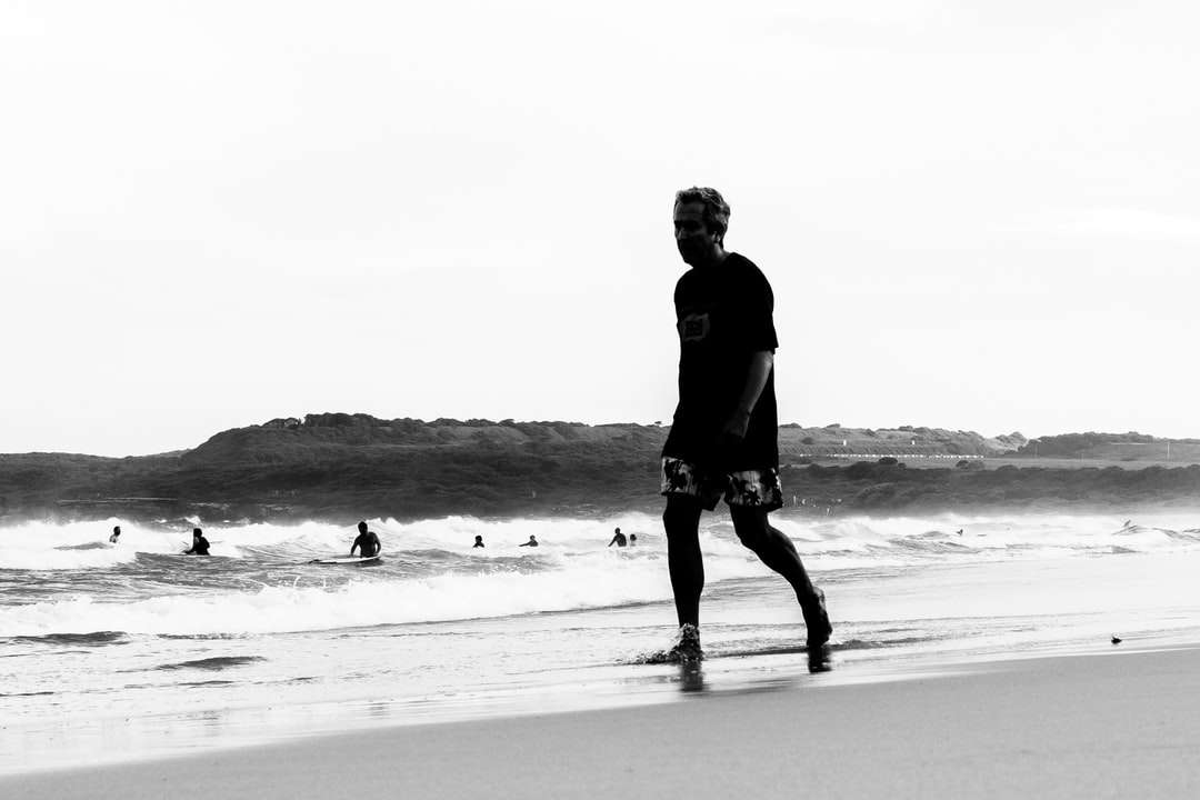 człowiek w czarnej kurtce spaceru na plaży puzzle online