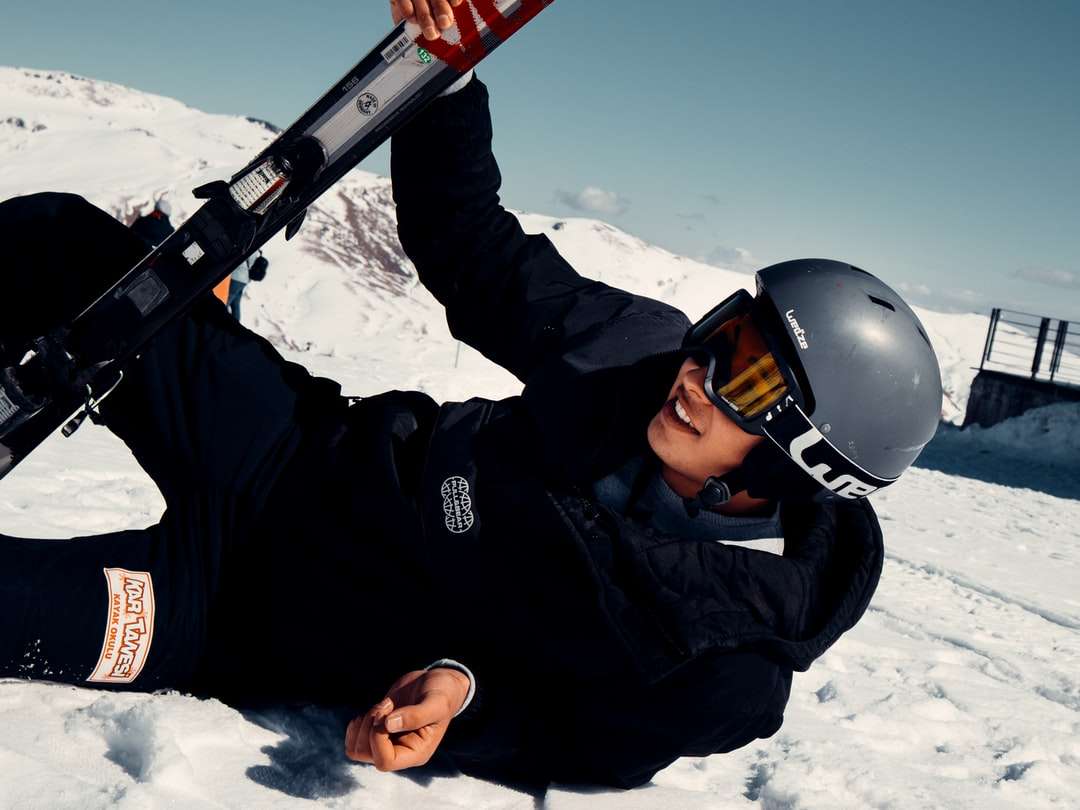 mężczyzna w czarnej kurtce, trzymając deskę narciarską śnieg czerwony i czarny puzzle online
