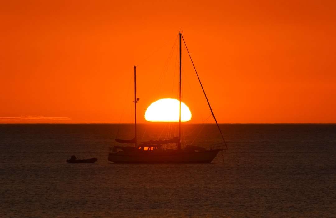 sylwetka łodzi na morzu podczas zachodu słońca puzzle online