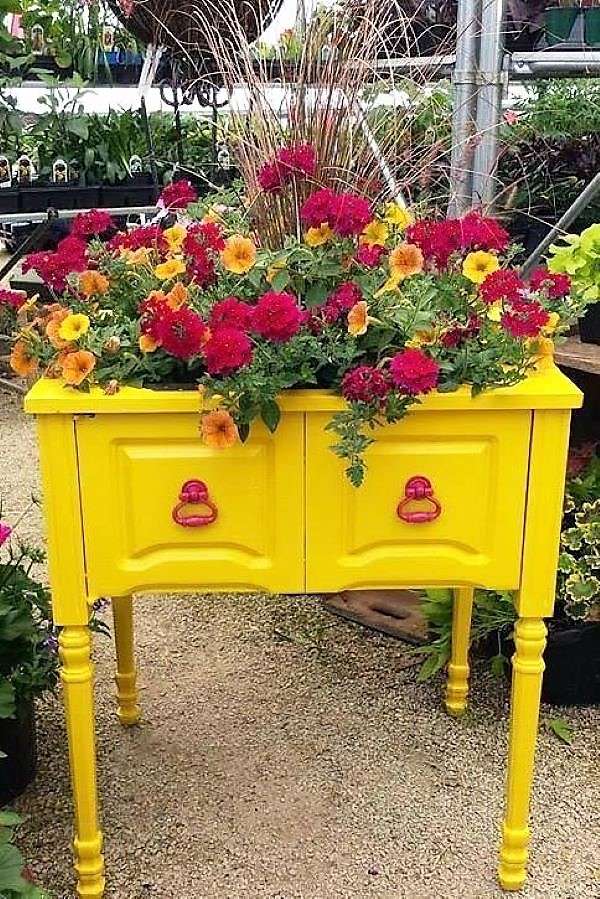Kwiecista dekoracja na żółtej szafce w ogródzie puzzle online