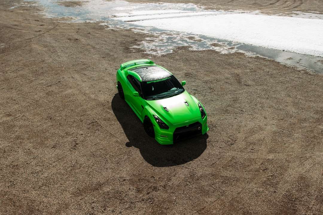 Zielony samochód na plaży w ciągu dnia puzzle online