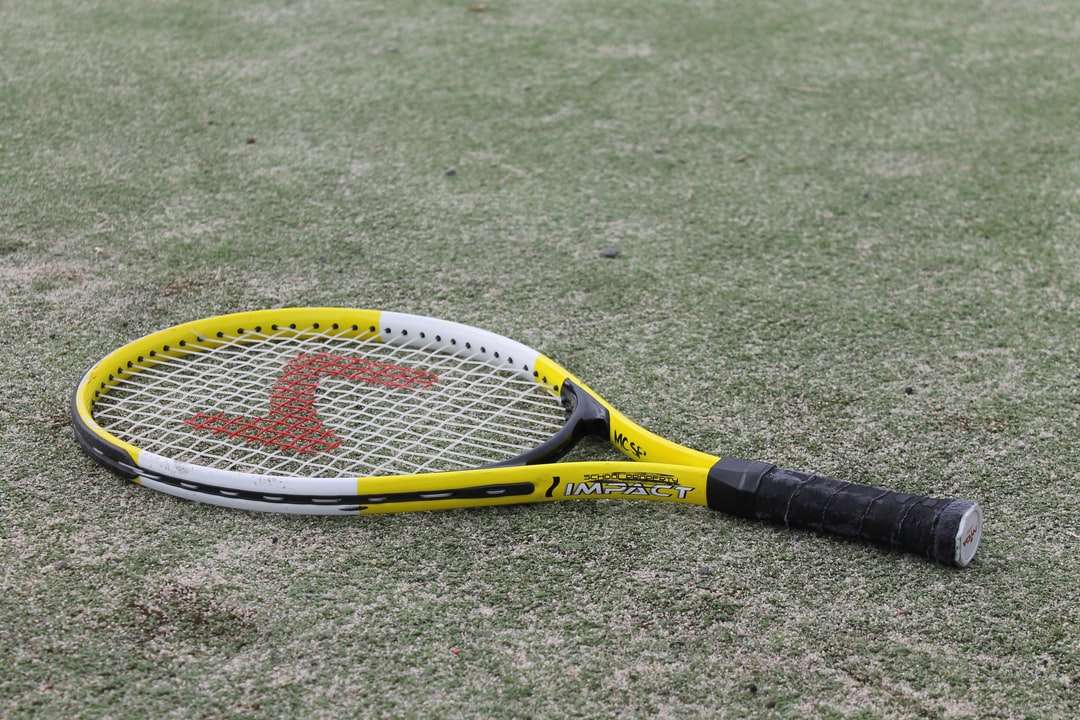 żółto-czarna rakieta tenisowa na zielonej trawie! puzzle online