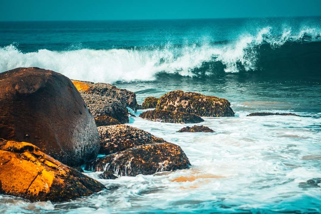brązowa formacja skalna na morzu w ciągu dnia puzzle online