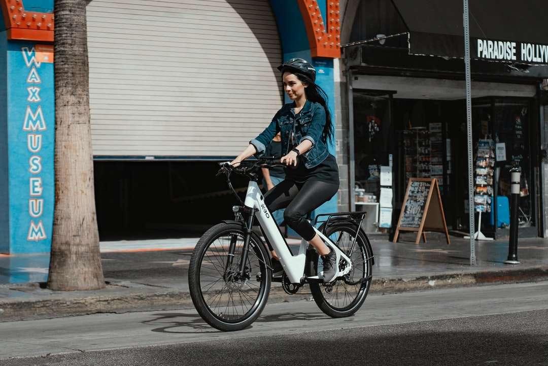 Kobieta w niebieskiej dżinsowej kurtce jazda na czarnym bicyklu puzzle online