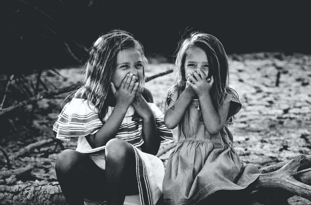 fotografia w skali szarości przedstawiająca dwie dziewczyny zamykające usta puzzle online