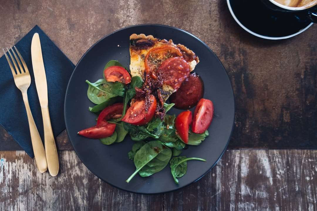 Pokrojony danie pomidorowe na czarnym talerzu puzzle online
