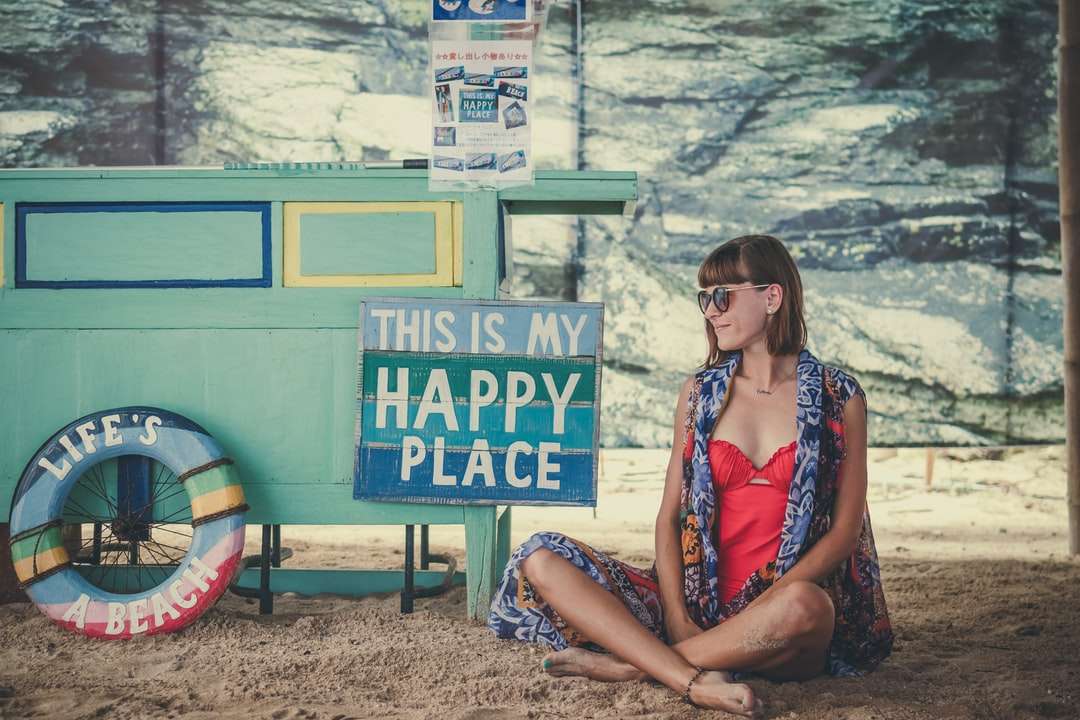 Kobieta siedzi na piasku obok puzzle online
