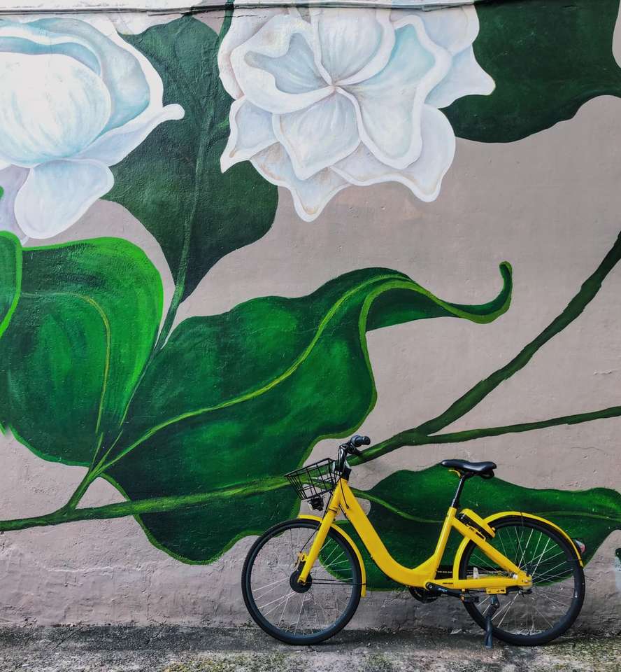 Żółty rower zaparkowany obok białych kwiatów graffiti puzzle online