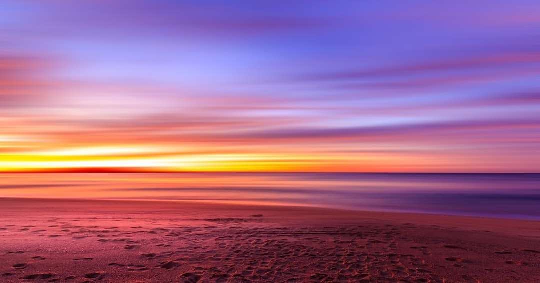 widok na zachód słońca nad brzegiem morza puzzle online