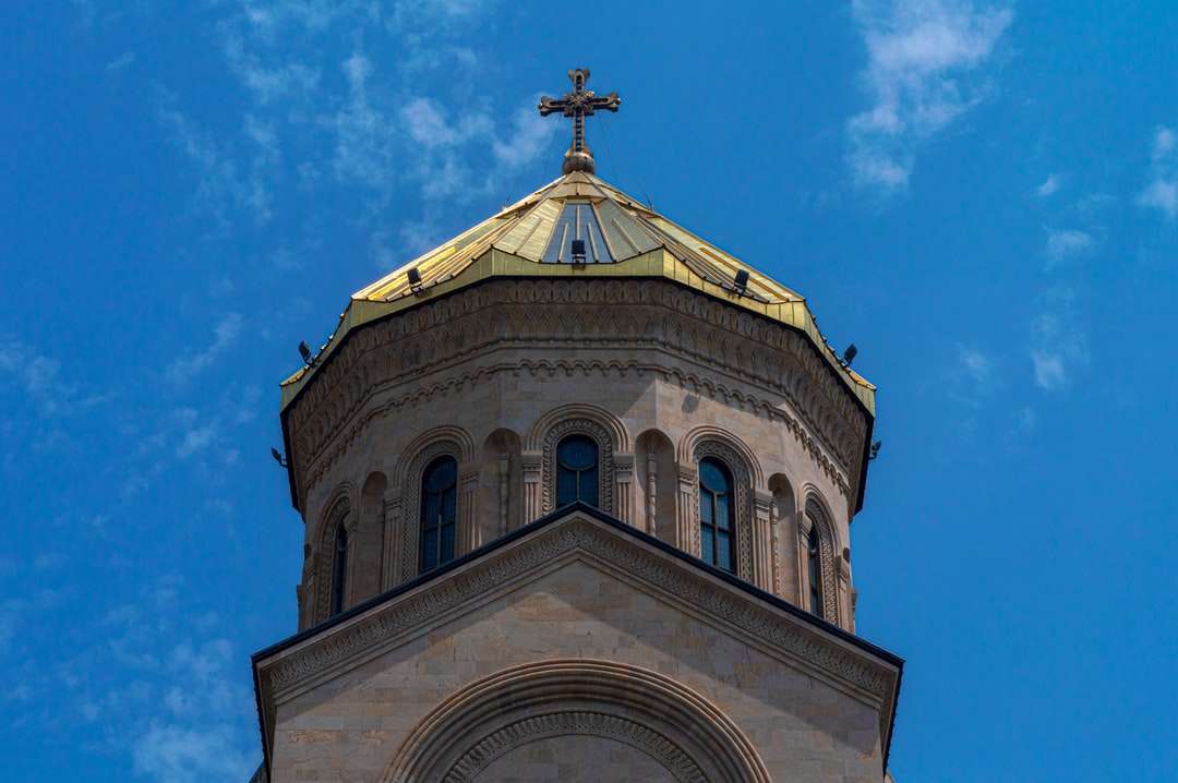 biało-brązowy betonowy kościół pod błękitnym niebem puzzle online