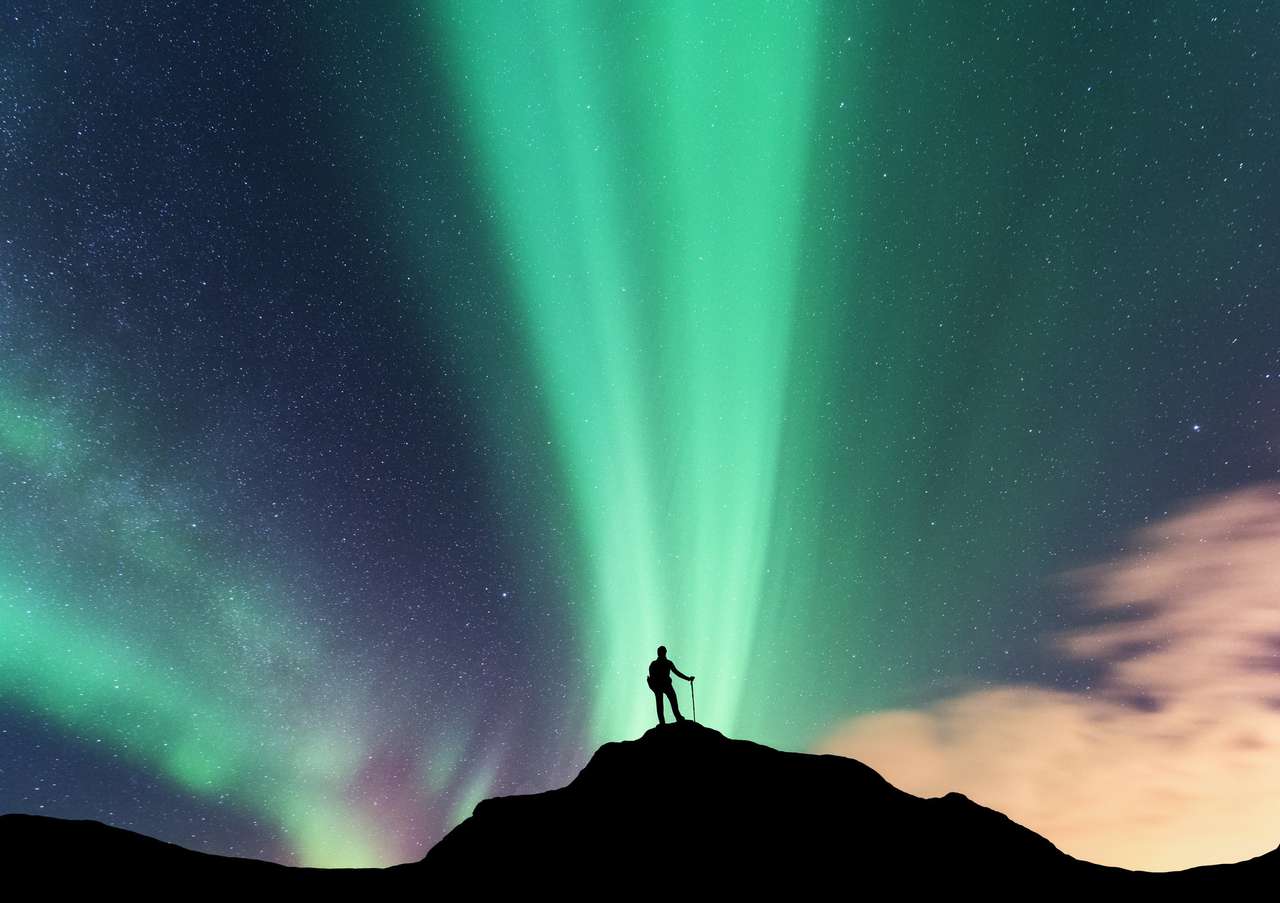 Aurora and woman on the top of mountain. puzzle