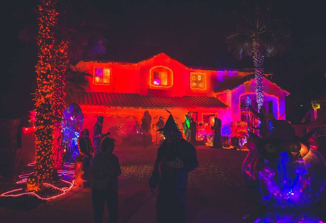 ludzie stojący w pobliżu domu z wystrojem w czerwonym świetle puzzle online