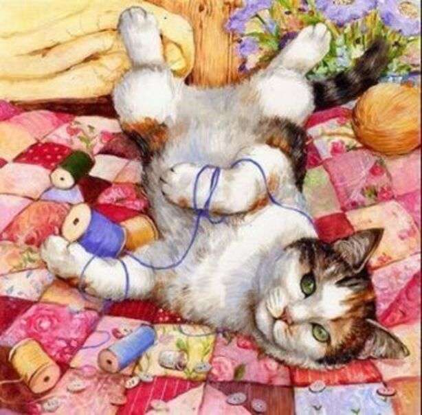 Kotek bawi się sznurkami w łóżku puzzle online