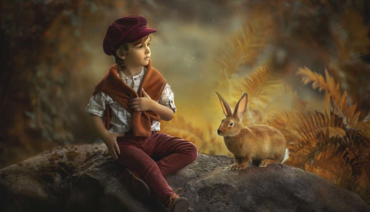 Chłopiec z królikiem na skale puzzle online
