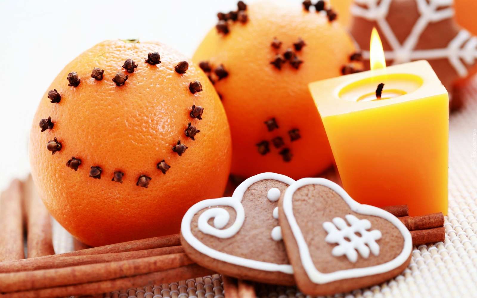 Pomarańcze i pierniczki obok świecy i cynamonu puzzle online